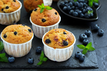 Oat muffins with blueberries on a dark background.