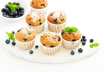 Oat muffins with blueberries on a dark background.