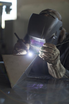 Blacksmith welding in workshop
