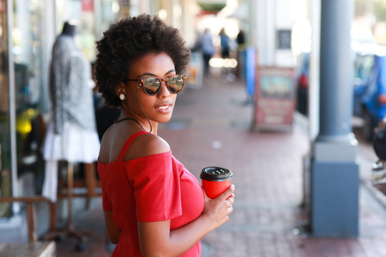 Afro woman holding a cup of coffee