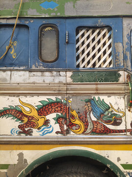 A truck with a dragon painted on its side.
