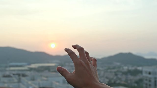 Hand touch the sunset
