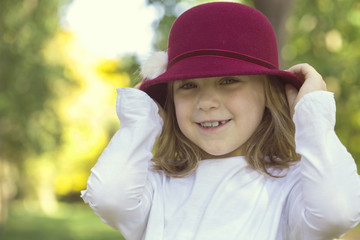 Portrait of a beautiful little girl with a hat