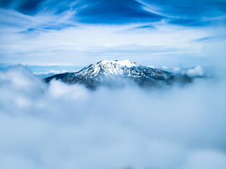 snow capped mountain lost in the clouds