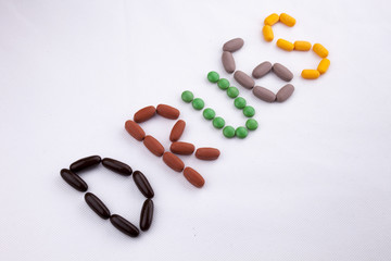 Conceptual Hand writing text caption inspiration Medical care Health concept written with pills drugs capsule word drug On white isolated background with copy space