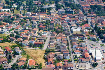 Fototapeta premium City aerial view over the Veneto region, Italy. Aerial view of typical houses with red roofs at residential Europe district in summer day. Сityscape