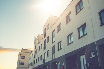 white townhouses with warm sunlight in the middle of the picture