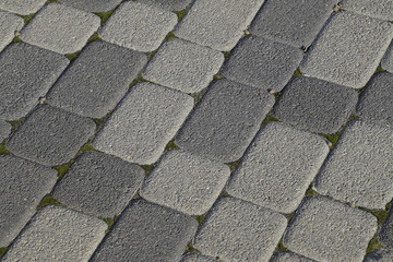 Industrial building background of paving slabs with overgrown wi