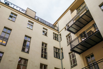 Naklejka premium yellow apartment house in low angle view