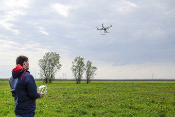 A man with a remote control in his hands. Flight control of the