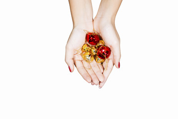 Hands of young woman hold Christmas bells