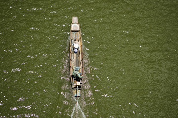 The  fisherman drive long tail boat in the lake
