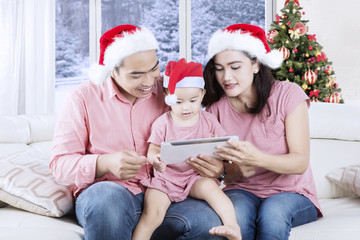Asian family with tablet at Christmas time