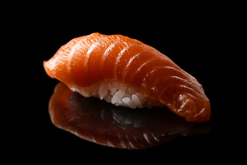 Closeup composition of fresh salmon sashimi sushi on a dark background