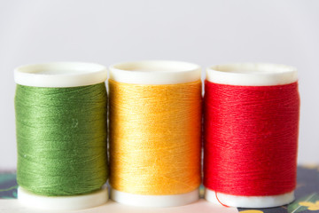 green, yellow and red thread close up