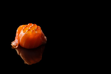 Sushi in salmon with caviar isolated on black background and copyspace.