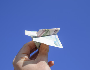 Denominations of Russian money, folded in the airplane against t