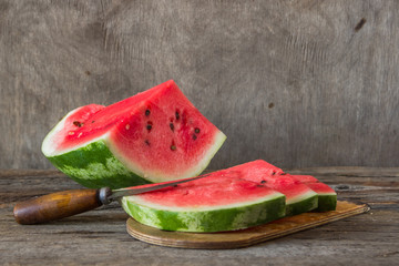 Watermelon slices on the woodan table. Fresh red watermelon. Rustical style.