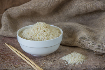 Rice in white ceramic bowl close up