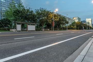 clean asphalt road through office block area, suzhou, china.