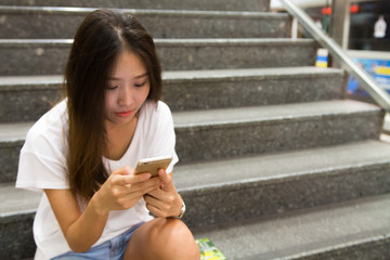 Beautiful Asian women using phone while communicating with internet or text. Dating, apply for a job or surfing concept.