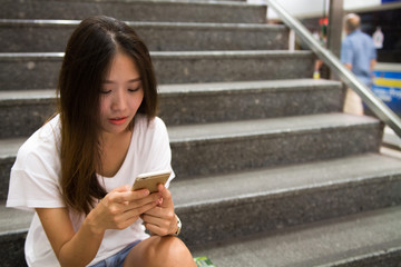 Beautiful Asian women using phone while communicating with internet or text. Dating, apply for a job or surfing concept.