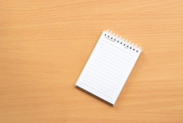 Notepad with pencil on wood board background.using wallpaper for education, business photo.Take note of the product for book with paper and concept, object or copy space.