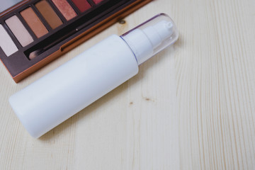 top view. cosmetic collection include colorful powder and bottle spray placed on wood table are background. image for skin care, cosmetic, makeup, women, beauty, art concept