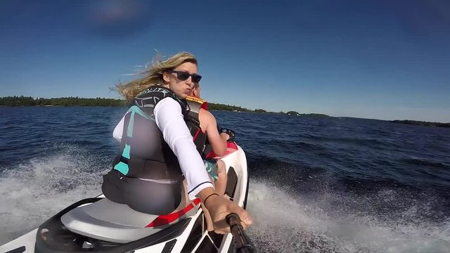 seadoo girl and guy riding fast selfie splashed camera laughing