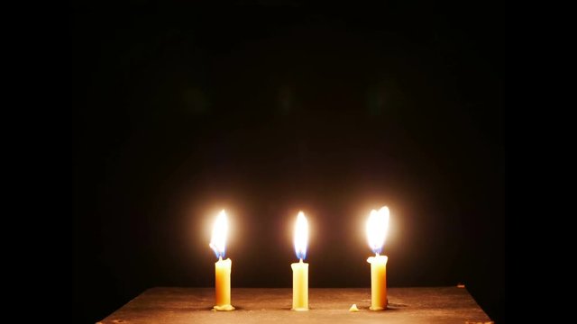 time lapse,Close up candle is burning on black background.