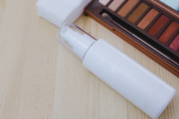 top view. cosmetic collection include colorful powder and bottle spray placed on wood table are background. image for skin care, cosmetic, makeup, women, beauty, art concept