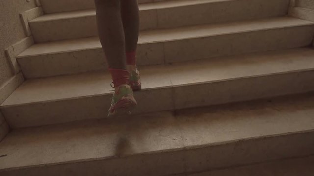 Sports girl running up the stairs