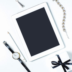 Women's jewelry and tablet pc on white background