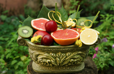 Still life with fruit. Fruit in a beautiful plaster vase. Bouquet with fruits 