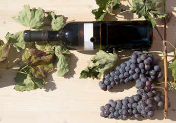 Red wine bottle with grapes
