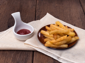 The french fries are placed in a cup with ketchup.