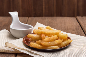 The french fries are placed in a cup with ketchup.