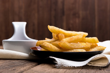 The french fries are placed in a cup with ketchup.