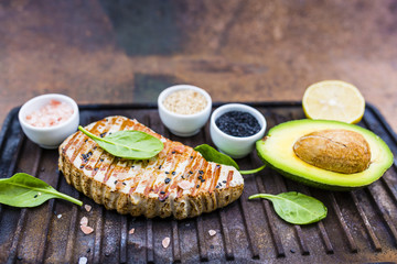 Grilled tuna steak with sesame and avocado.