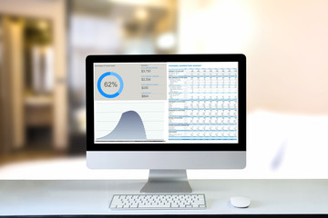 Fototapeta premium Computer desktop on office table showing charts and graph against office background,Computer Analysis Business, Statistics Concept.