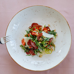 Green salad with Parma ham and Tomato. Sprinkle with parmesan cheese. Healthy food style - Processing Warm White balance. Healthy vegetables salad.