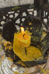 Candle flame in the glass cabinet for worship.