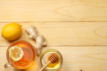 healthy background. honey, honeycomb, lemon, tea, ginger on white wooden table. Top view with copy space