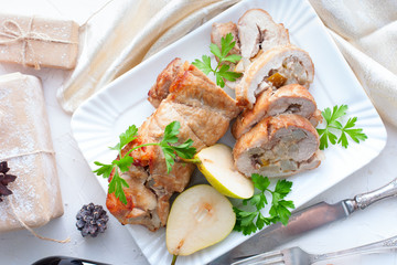 Meatloaf with pear on festive table, horizontal