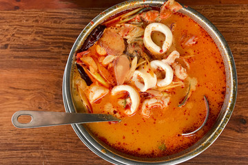 Tom Yum Goong put on a wooden table top view