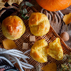 Pumpkin roll with tea in autumn decorations with plaid rug and tea, top view, selective focus