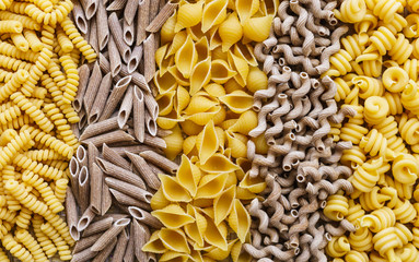 noodles, pasta of different kinds, scattered on the table.