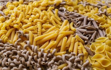 noodles, pasta of different kinds, scattered on the table.