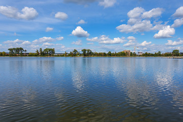 blue cloudy sky reflected in a beautiful quiet lake