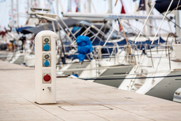 electrical outlets for charging on boats in the harbor background
